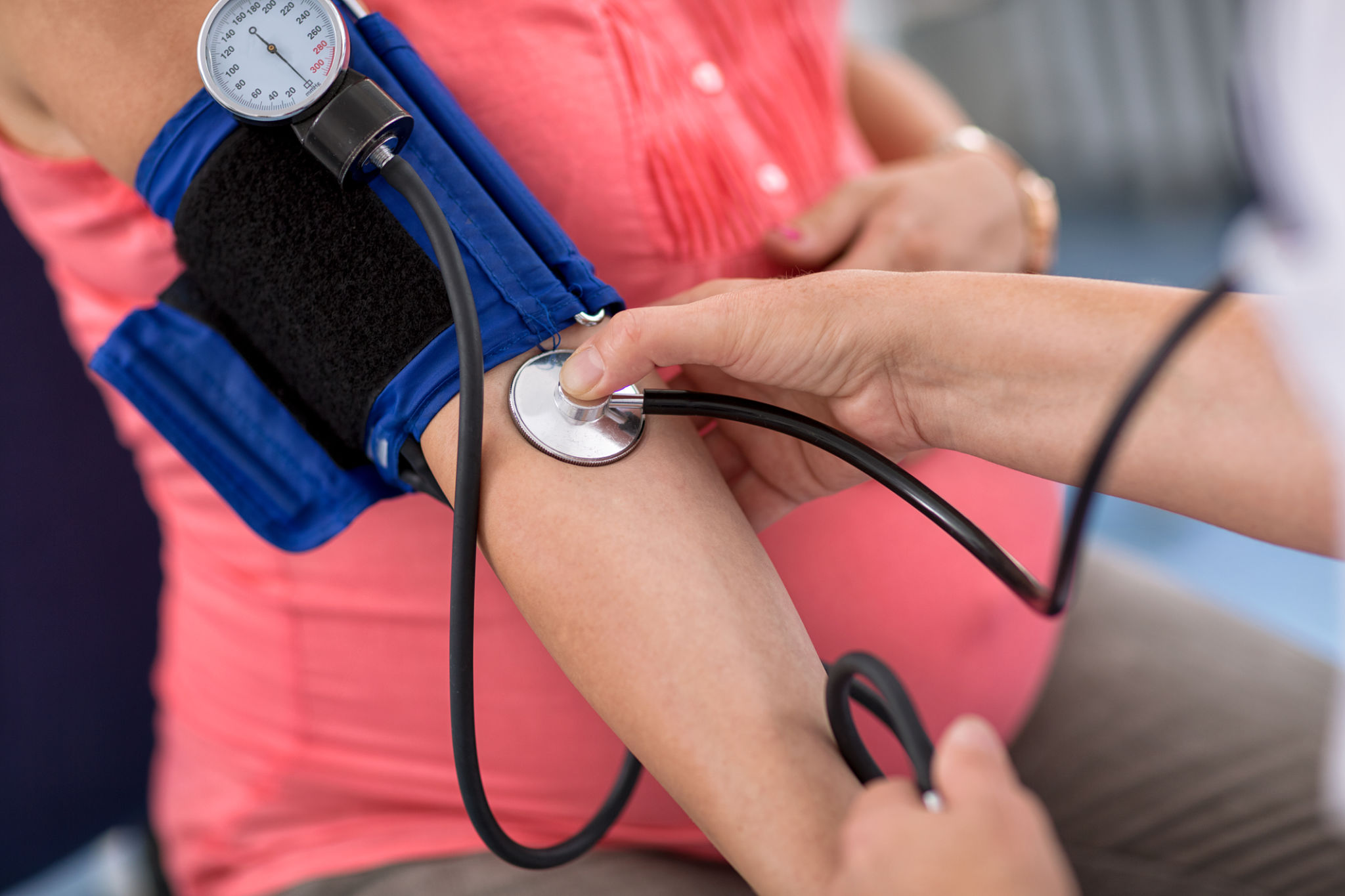 Nurse checking blood pressure of a pregnant woman in ambulances, close up