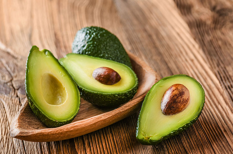 Cut Avocados are kept in a bowl - Emoha