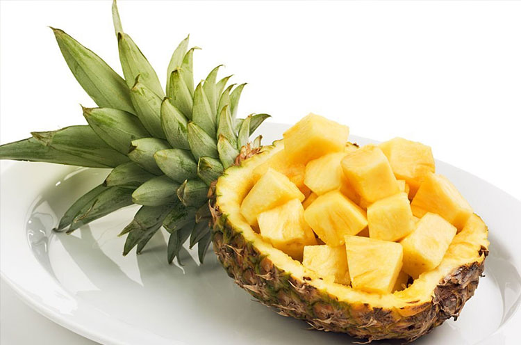 Cut Pineapple kept in a plate - Emoha