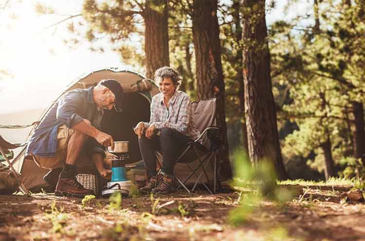 Seniors setting up a camping tent